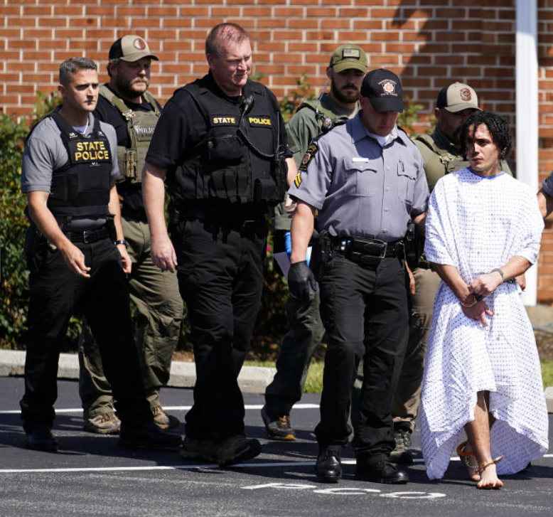 Controversial Photo: Officers Pose with Captured Escaped Murderer